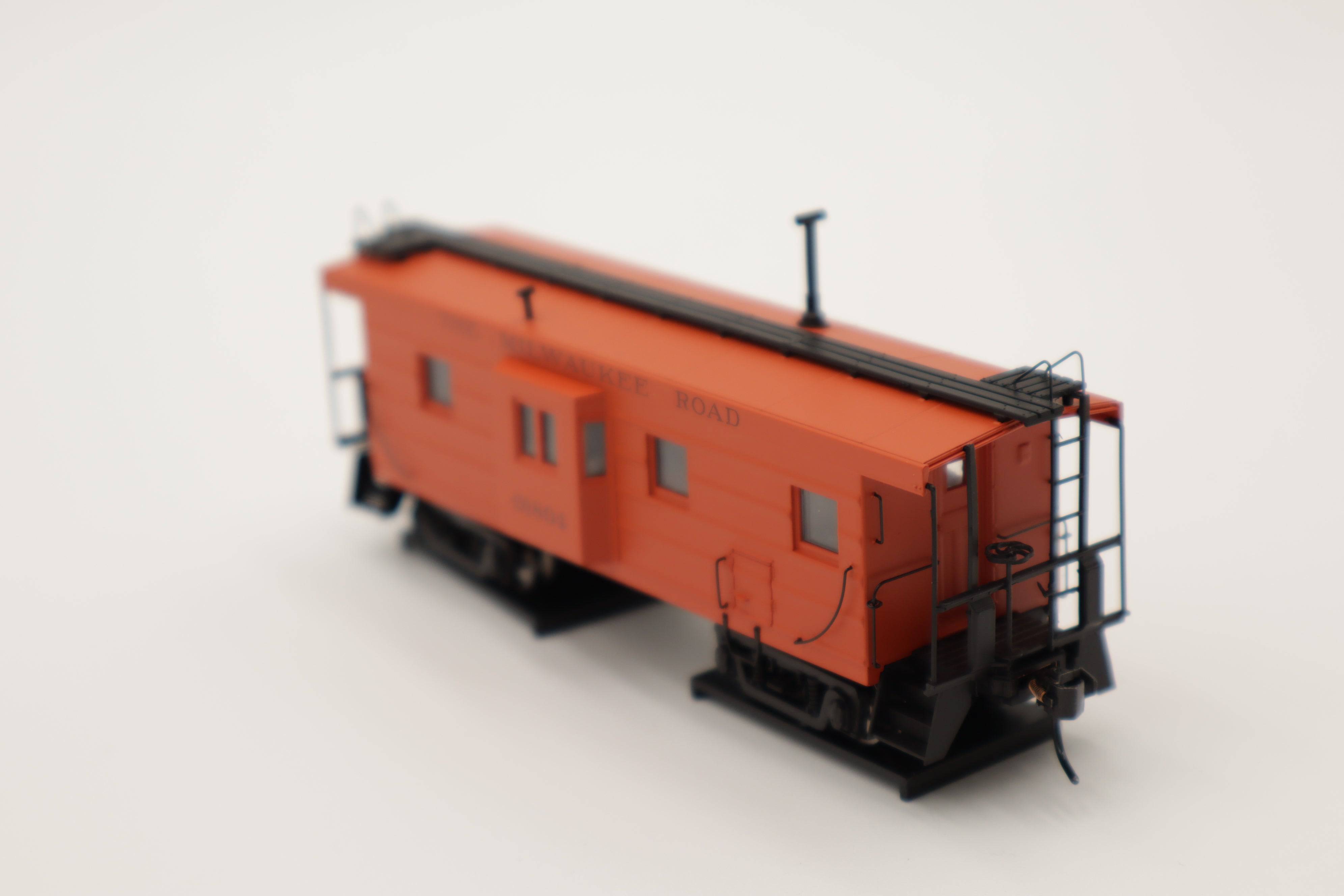 Walthers HO 920-103651 - Proto -  Rib Sided Caboose "Milwaukee Road" #01804 (Orange, Maroon; Includes Coal Stove)