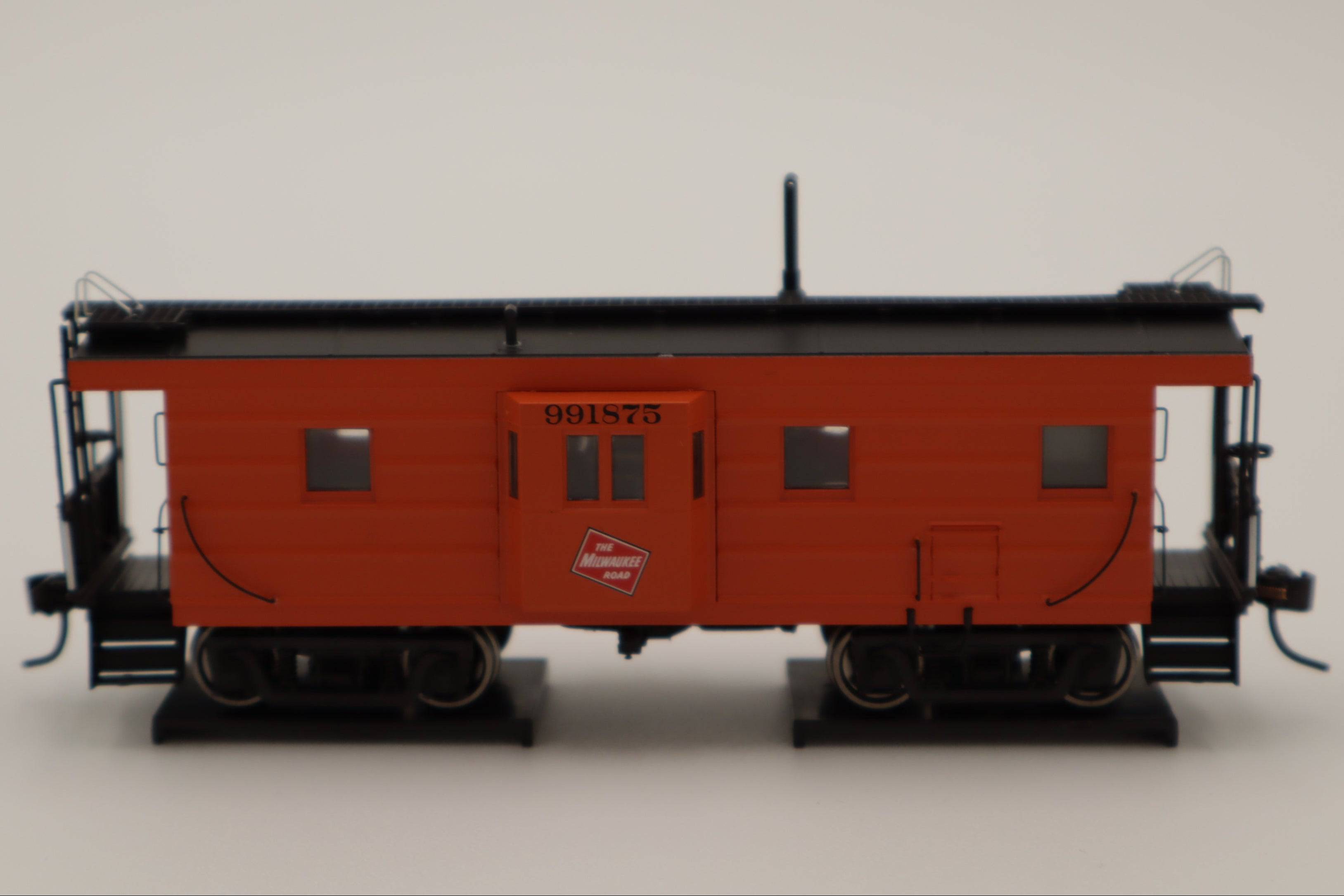Walthers HO 920-103655 - Proto -  Rib Sided Caboose "Milwaukee Road" #991875 (Orange, Black; Includes Oil Stove)