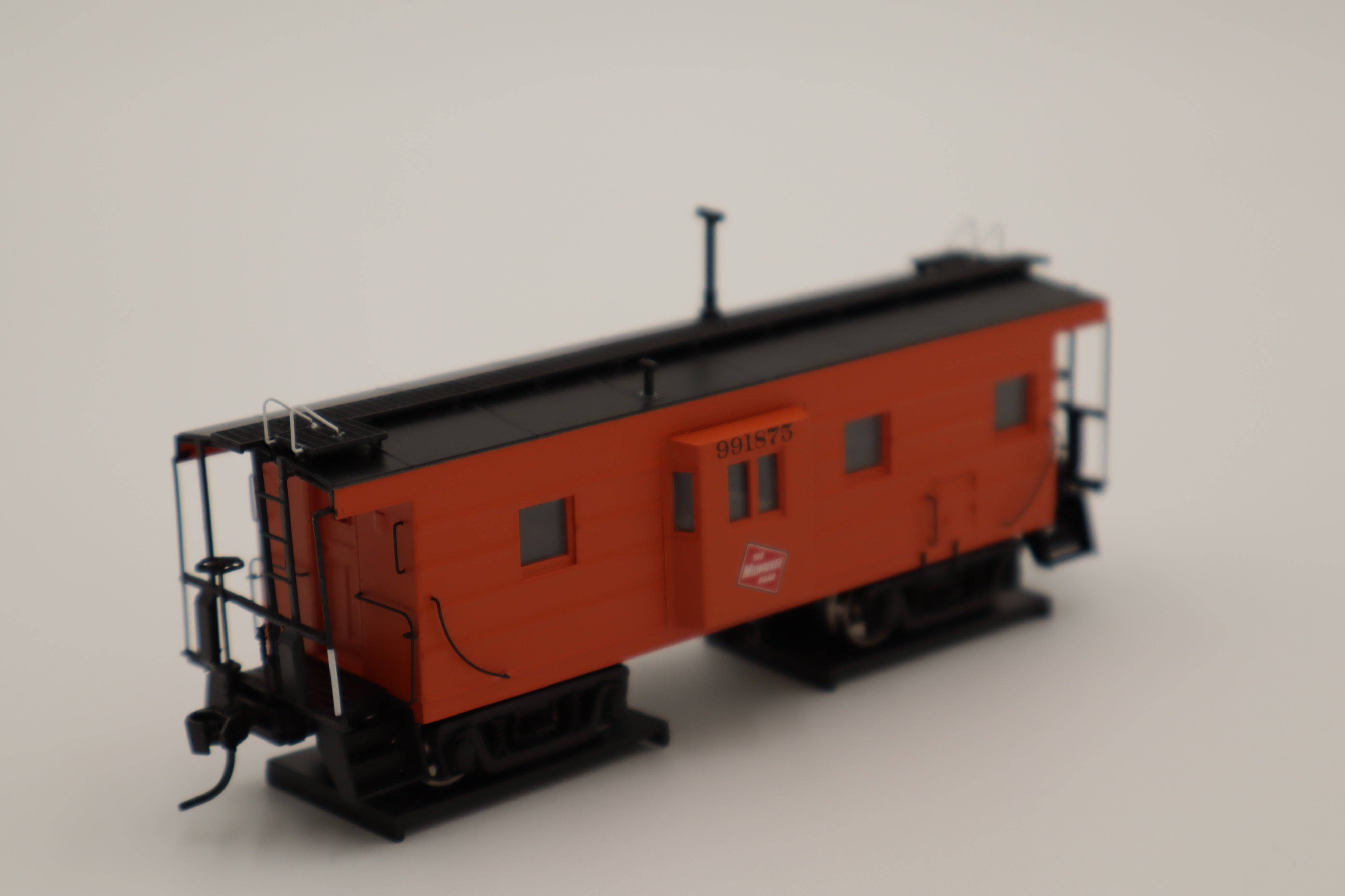 Walthers HO 920-103656 - Proto -  Rib Sided Caboose "Milwaukee Road" #991898 (Orange, Black; Includes Oil Stove)