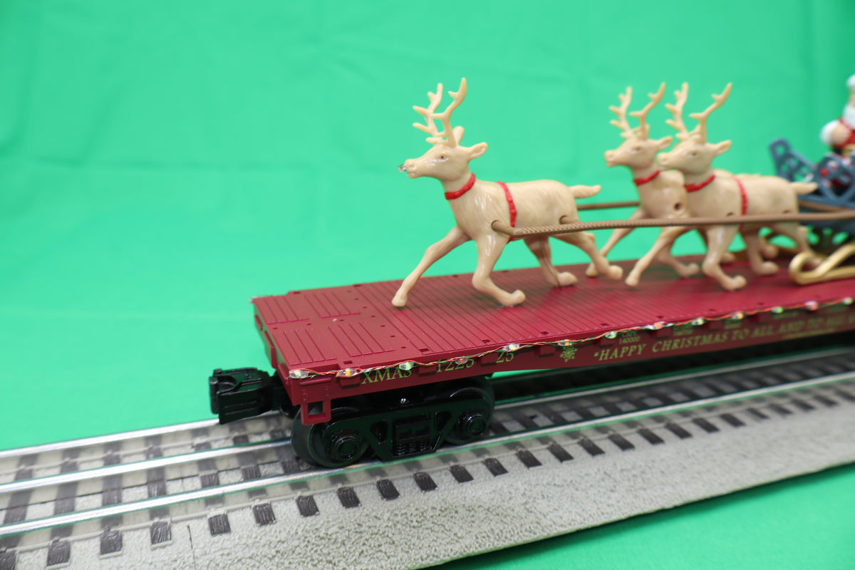 MTH 30-76946 - RailKing - Flat Car "North Pole" #122525 w/ LED Lights, Santa Sleigh & Reindeer (Red)