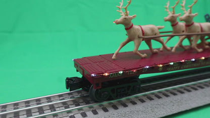 MTH 30-76946 - RailKing - Flat Car "North Pole" #122525 w/ LED Lights, Santa Sleigh & Reindeer (Red)